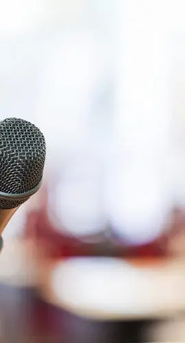 Close-up of a microphone at a government meeting, symbolizing public hearings and municipal legal services.