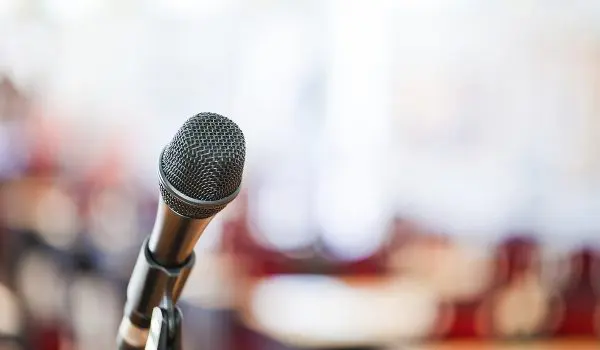 Close-up of a microphone at a government meeting, symbolizing public hearings and municipal legal services.