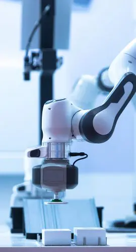 A modern industrial robotic arm performing a task on a production line.