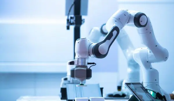 A modern industrial robotic arm performing a task on a production line.