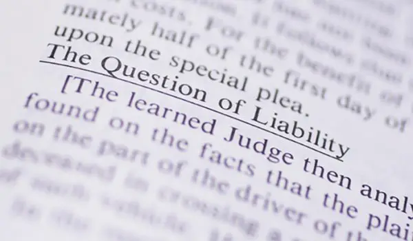 A close-up shot of a page in a book highlights the phrase "The Question of Liability."