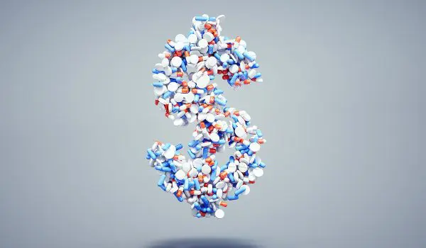 A dollar sign is formed by an assortment of various pills and capsules.
