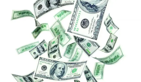 US dollar bills are flying and scattered in the air.