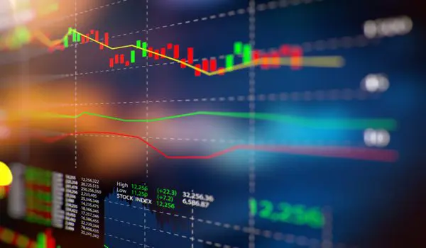 A colorful financial graph displays a variety of fluctuating stock market trends and data on a screen.