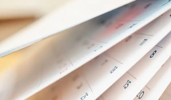 An open calendar with its pages fanned out and dates visible.
