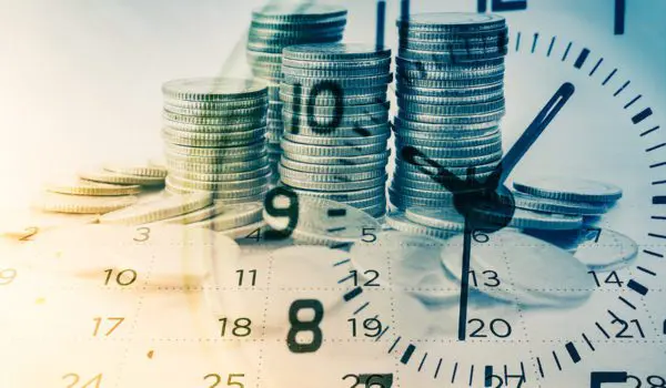 Stacks of coins are overlaid with the image of a clock.