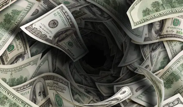 A swirling vortex surrounded by numerous U.S. dollar bills.