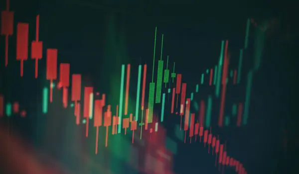 A fluctuating stock market graph with red and green candlestick patterns.