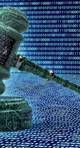 A gavel made of digital code rests on a surface with rows of binary digits in the background.