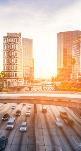 Sun rising behind cityscape