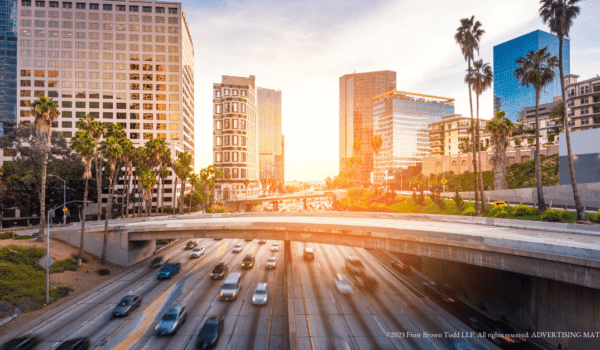 Sun rising behind cityscape