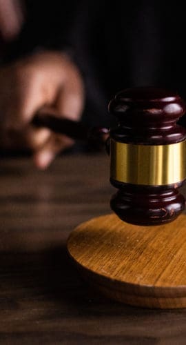 Brown wooden gavel on brown wooden table