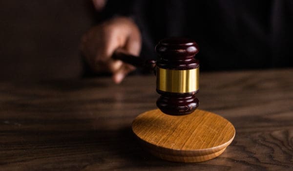 Brown wooden gavel on brown wooden table