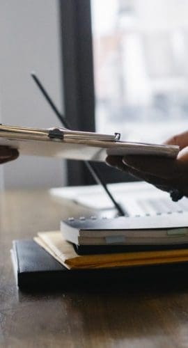 Crop black job candidate passing resume to hr employee