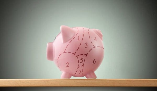 Piggy bank divided into seven parts with a dashed line.