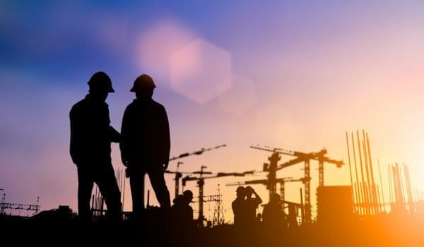 Silhouette of engineer and construction team working at site over blurred background for industry background with Light fair.Create from multiple reference images together