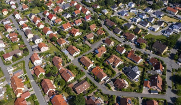 Aerial view above suburb homes in residential neighborhood.