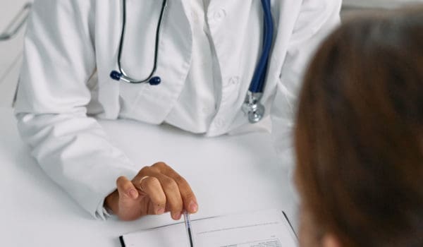A medical practitioner showing a patient paper