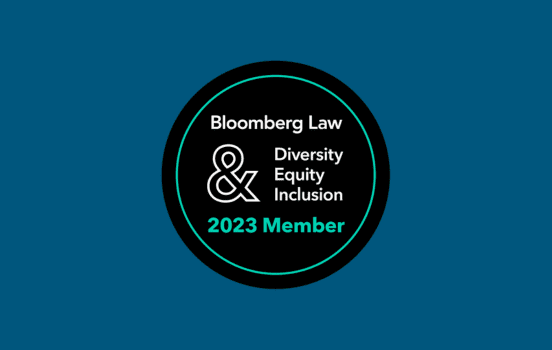 A circular badge with "Bloomberg Law & Diversity Equity Inclusion 2023 Member" written inside on a dark background.