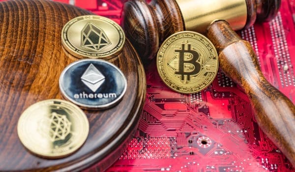 Different cryptocurrencies and gavel over computer mainboard.Concept image for cryptocurrency
