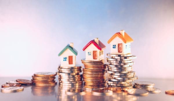 Miniature colorful house on stack coins using as property and financial concept
