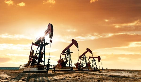 Oil pumps working under the sunrise sky