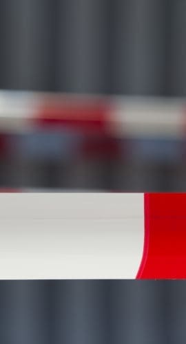 Red tape against dark background. Exclusion zone. Adobe RGB for better color reproduction.