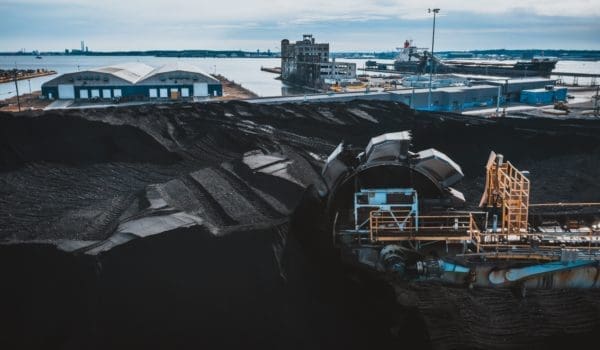 Machine digging coal in industrial area