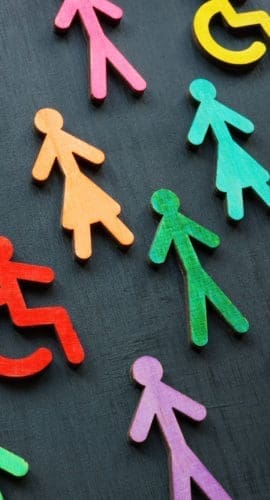 Colorful figurines on the dark surface. Diversity and inclusion concept.
