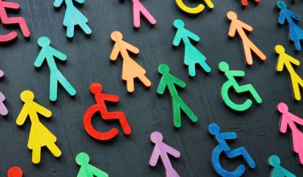 Colorful figurines on the dark surface. Diversity and inclusion concept.