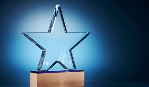crystal star shape trophy against blue background