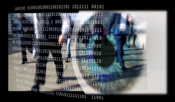 "Montage of an eye, binary code and people walking on a city pavement."