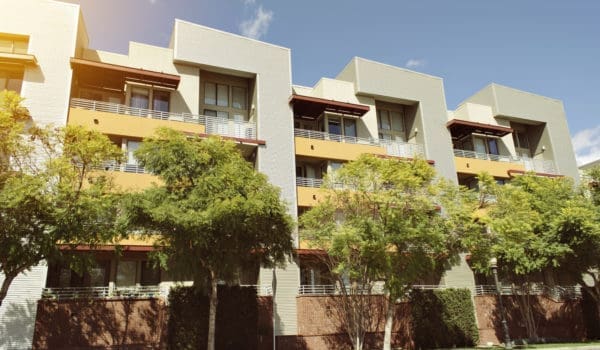 View of modern apartment building on a sunny day with warm lighting