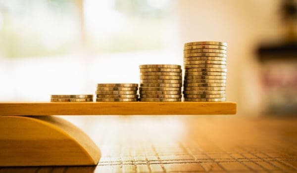 Coins stack with balance scale. Money management, financial plan, time value of money, business idea and Creative ideas for saving money concept.