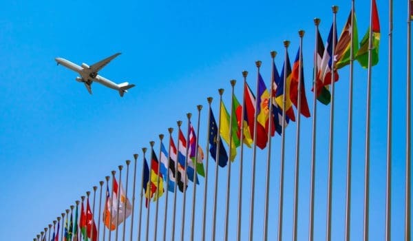 airplane flying over the national flags