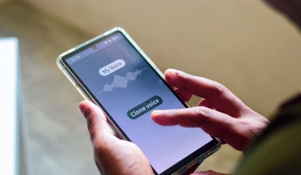 Man using mobile applications for cloning his voice. Selective focus.