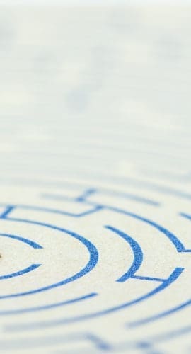 Reducing, removing or overcome financial barrier, financial concept : US dollar bag on a maze puzzle. The image depicting a situation how to overcome financial difficulties and avoid a financial distress.