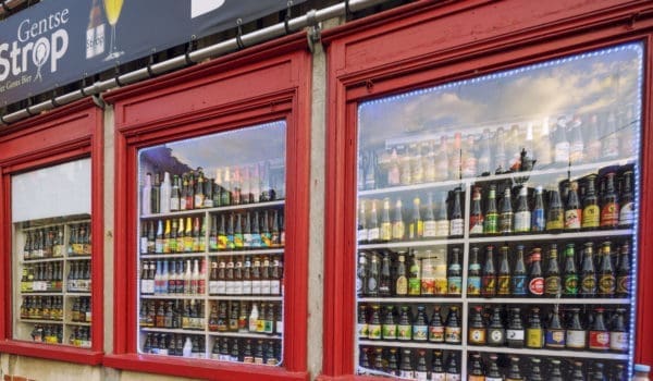 Beer Store's Window in Ghent, Belgium. Beer in Belgium varies from pale lager to amber ales, lambic beers, Flemish red ales, sour brown ales, strong ales and stouts. There are approximately hundreds of active breweries in Belgium.