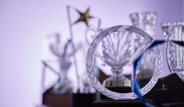 group of  crystal trophies against purple background