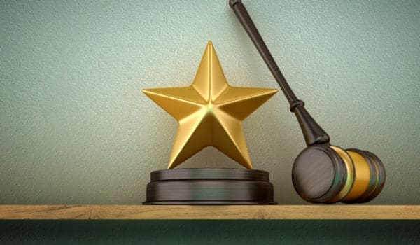 Legal Gavel with Golden Star on Shelf - Wall Background - 3D Rendering