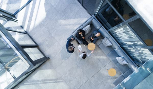 Business people, high angle and meeting in building with collaboration, financial pitch with document for strategy. Above, tax accountant and table teamwork with budget paper for economy in office