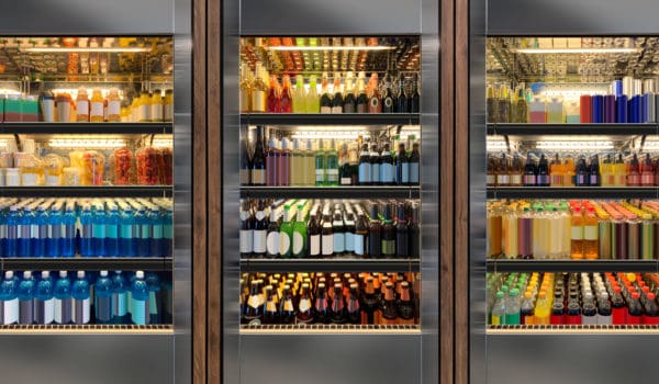 Glass door fridges photo mockup. Soda pop cans, vine and beer bottles in vertical freezer at airport restaurant.
Suitable for presenting new cans and bottles among many others.