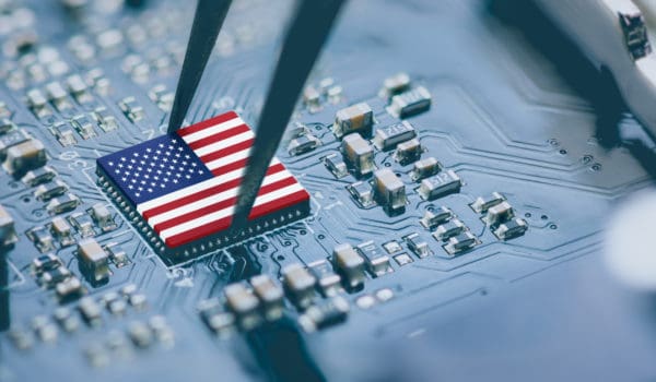 Flag of USA on a processor, CPU Central processing Unit or GPU microchip on a motherboard. Congress passes the CHIPS Act of 2022 to strengthen domestic semiconductor manufacturing, research and design.