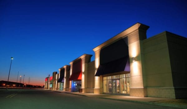 Retail shopping center with custom-built storefronts, representing reverse built-to-suit real estate transactions for investors and landlords