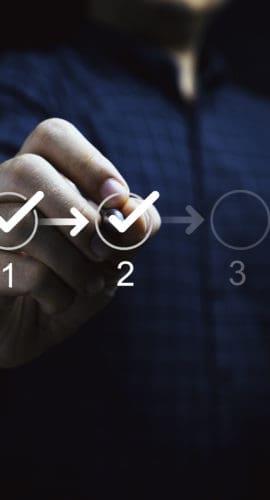 Businessman touching to tick correct mark in checklist to remind work task progressive for project develop management and tracking concept.