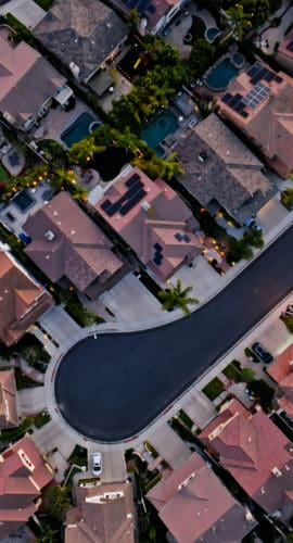 Top down aerial shot of residential streets in Tustin, a city in Orange County, California, at sunset.